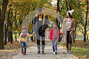 Happy family with children spending time together in park.