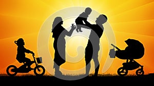 Happy family with children at sunset silhouette.