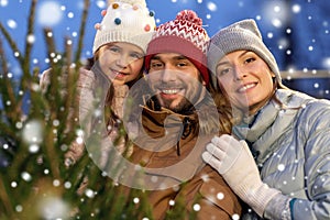 Happy family choosing christmas tree at market