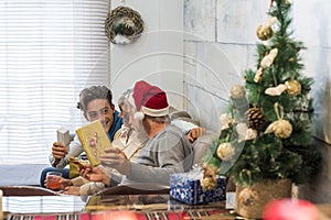 Happy family in christmas eve day with grandfathers and grandson teenager having fun with gift exchange activity at home on the