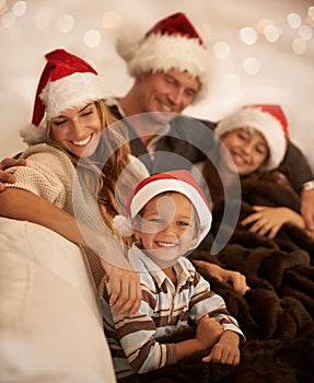 Happy family, christmas hat or bonding on house or home living room sofa in celebration holiday or festive vacation