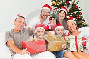 Happy family at christmas holding gifts