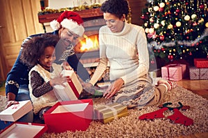 Happy family in Christmas morning opening present photo