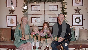 Happy family with Christmas presents celebrating.