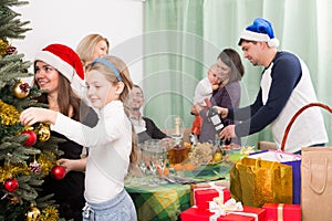 Happy family with Christmas tree at home