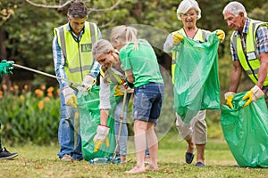 Happy family collecting rubbish