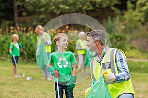 Happy family collecting rubbish