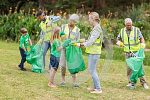 Happy family collecting rubbish