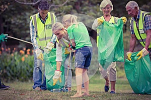 Happy family collecting rubbish