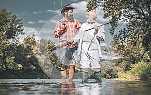 Happy family concept - father and son together. Fly angler on the river. Fishing in river. Man fishing. Generations men