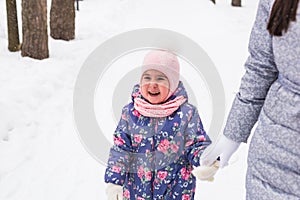 Happy family concept - Mother and child girl on a winter walk in nature.