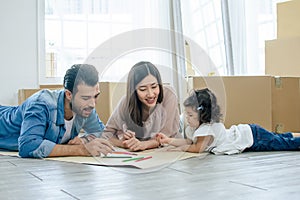 Happy family consists of caucasian handsome father, Asian beautiful mother and little cute daughter doing activitiy, playing