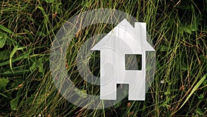Happy family construction house concept. paper house stands in the green grass in lifestyle nature. life symbol ecology