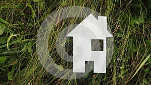 Happy family construction house concept. paper house stands in the green grass in nature lifestyle . life symbol ecology