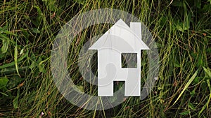 Happy family construction lifestyle house concept. paper house stands in the green grass in nature. symbol life ecology