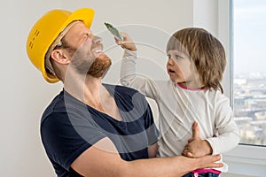 Happy family, construction worker in helmet and small child