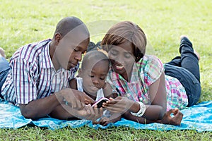 Happy family consulting a mobile phone.
