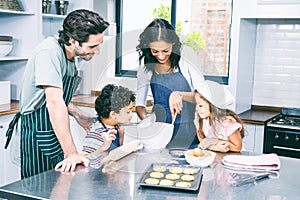 Happy family cooking biscuits together