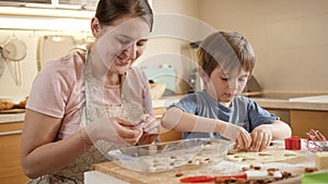 Happy family cooking and making biscuits at home. Children cooking with parents, little chef, family having time