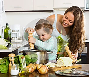 Happy family cooking soup