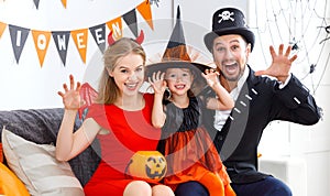 Happy family in costumes getting ready for halloween
