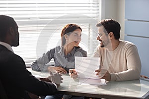 Happy family couple clients meeting african american financial consultant.