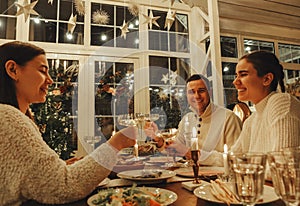 Happy family couple clinking champagne glasses while celebrating