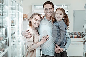 Happy family cuddling and smiling in the pharmacy