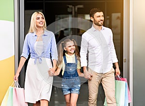 Happy Family Customers Leaving Mall Carrying Shopper Bags