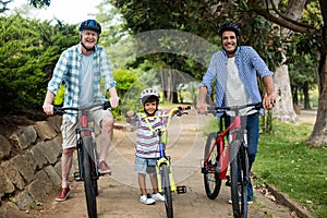 Happy family cycling in park