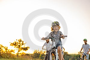 Happy family cycling together