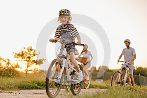 Happy family cycling together