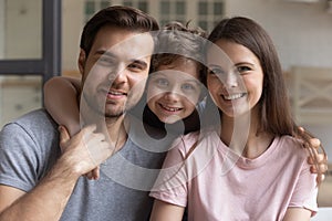 Happy family dad mom and little son posing for camera