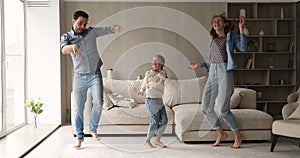 Happy family with daughter dancing together at home