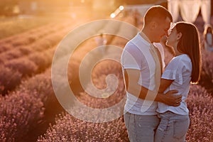 happy family day. young father, mother and child daughter are having fun together in the lavender field on sunset. happy