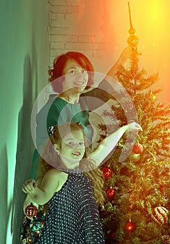 Happy family decorate Christmas tree