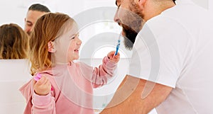 Happy family, dental and brushing teeth with girl and father in bathroom for hygiene, learning and grooming. Love, teeth