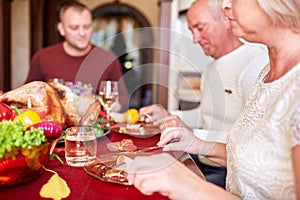 Happy family dining on Christmas on a blurred festive background. Celebrating Thanksgiving concept. Happy new year.