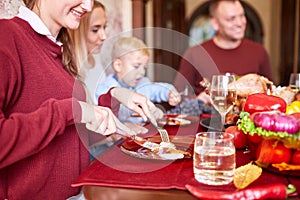 Happy family dining on Christmas on a blurred festive background. Celebrating Thanksgiving concept. Happy new year.