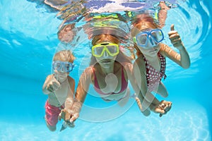 Happy family dive underwater with fun in swimming pool