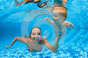 Happy family dive underwater with fun in swimming pool
