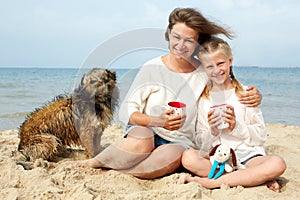 Happy family with dog on the beach