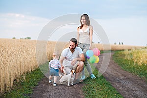 Happy family and dog enjoy outdoor time together