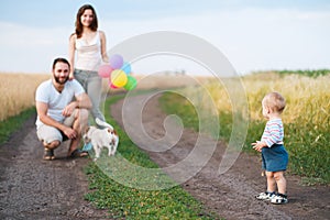 Happy family and dog enjoy outdoor time together