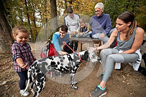 Happy family with a dog having a picnic together; Healthy lifestyle concept