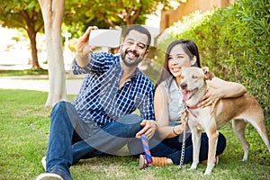 Happy family with a dog taking selfie