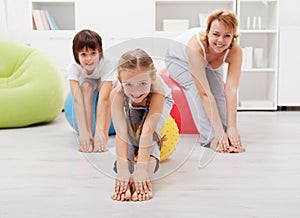 Happy family doing stretching exercises at home