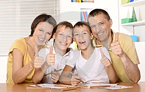 Happy family drawing at the table together