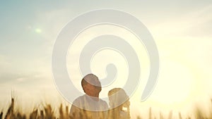 Happy family dreams concept. father throws daughter up playing in the field with wheat silhouette. dad play with a