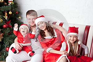 Happy family dressed in Santa costumes